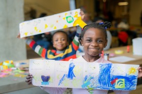 children holding artwork